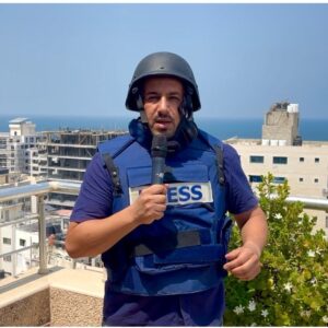 Photo of Yousef Alhelou wearing a PRESS vest