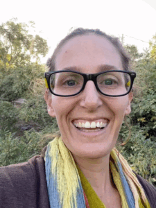 Morgan Cooper wearing glasses and smiling at the camera