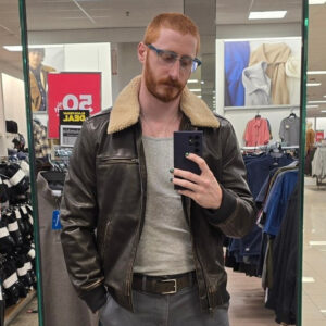 The History Wizard taking a selfie in a full-length mirror at a department store